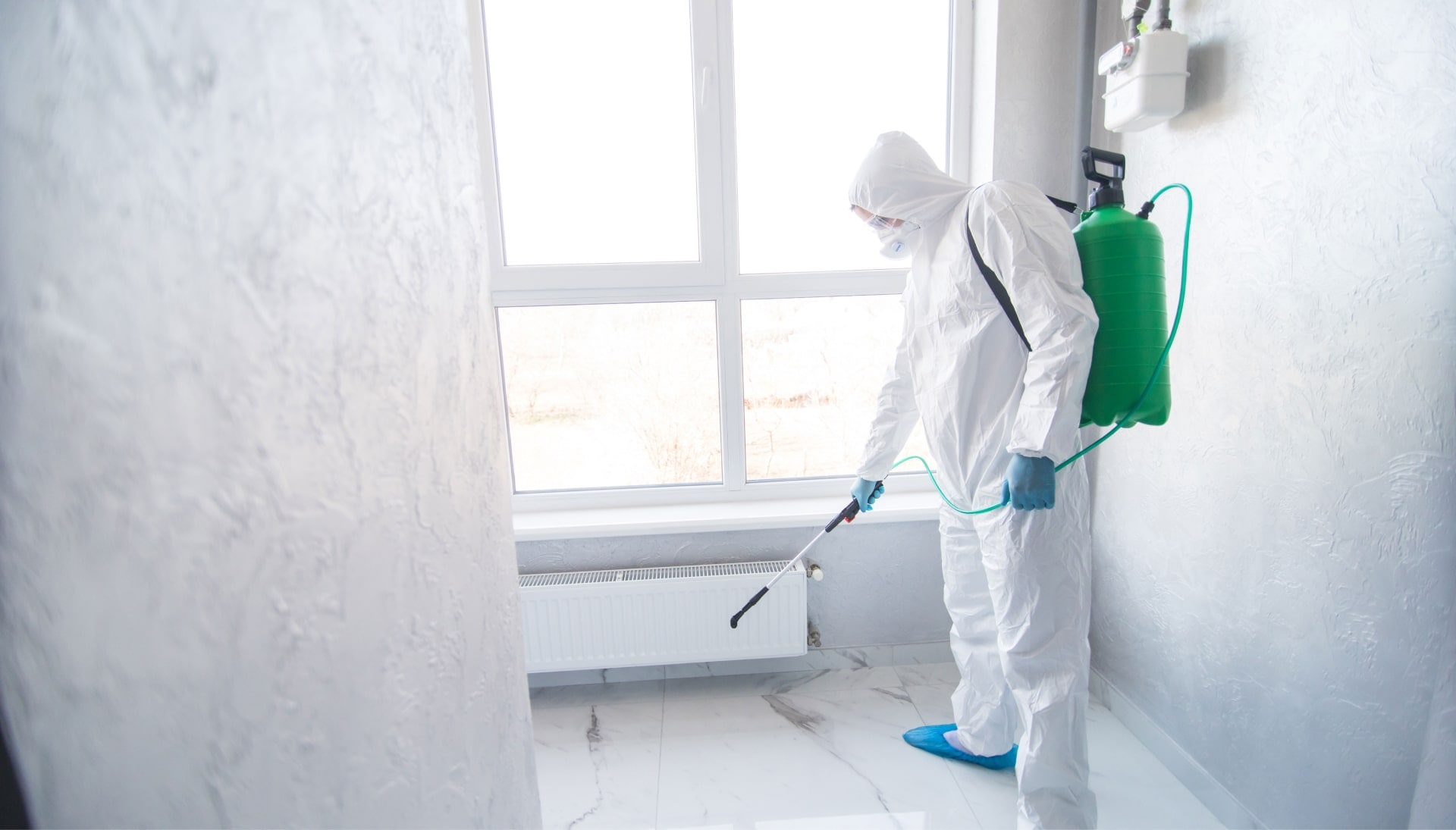 A mold inspector collecting air samples for laboratory analysis to test for mold spores in a residential property in Lansing.